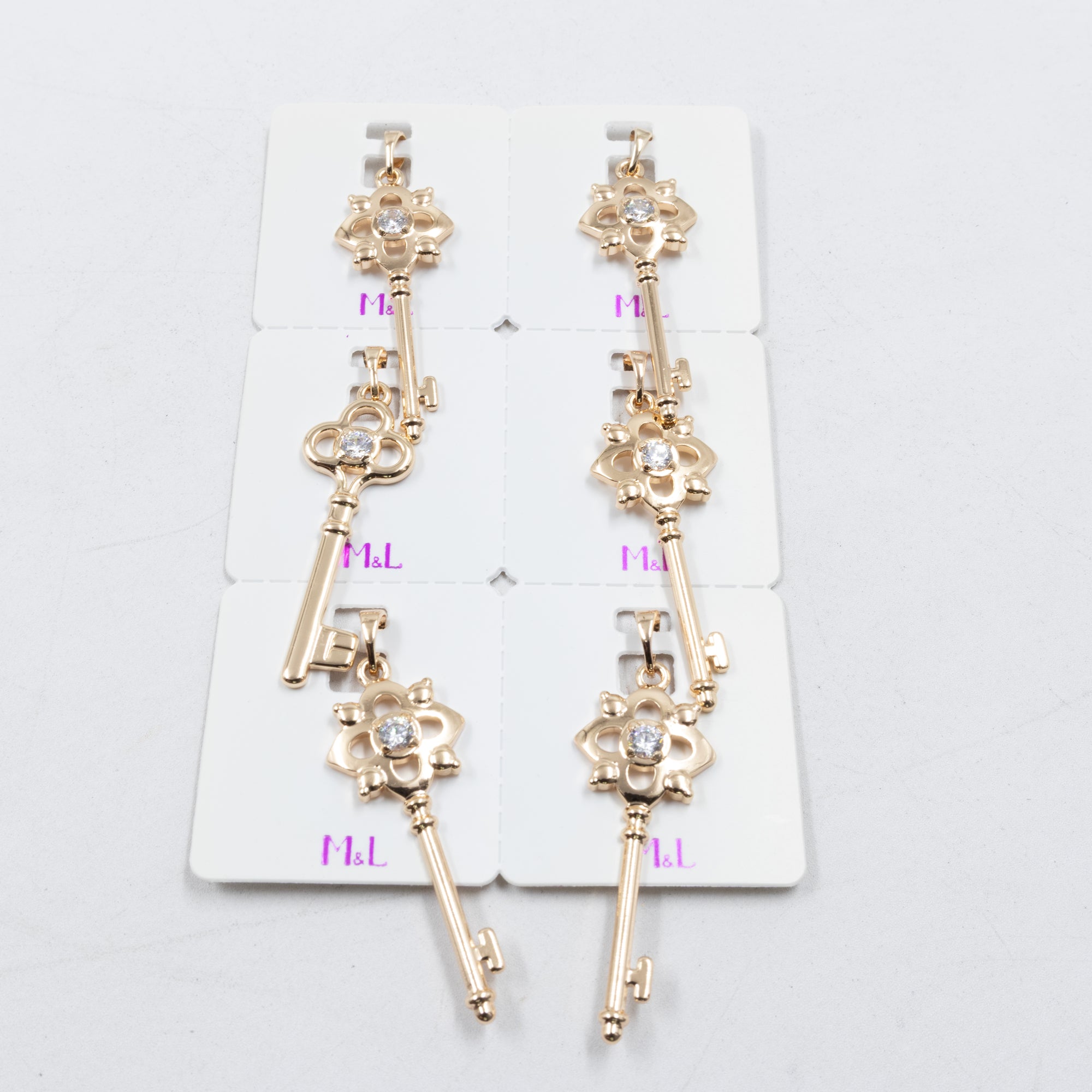 Paquete de 6 dijes con Piedras Oro Rosado  M1 Oro Laminado